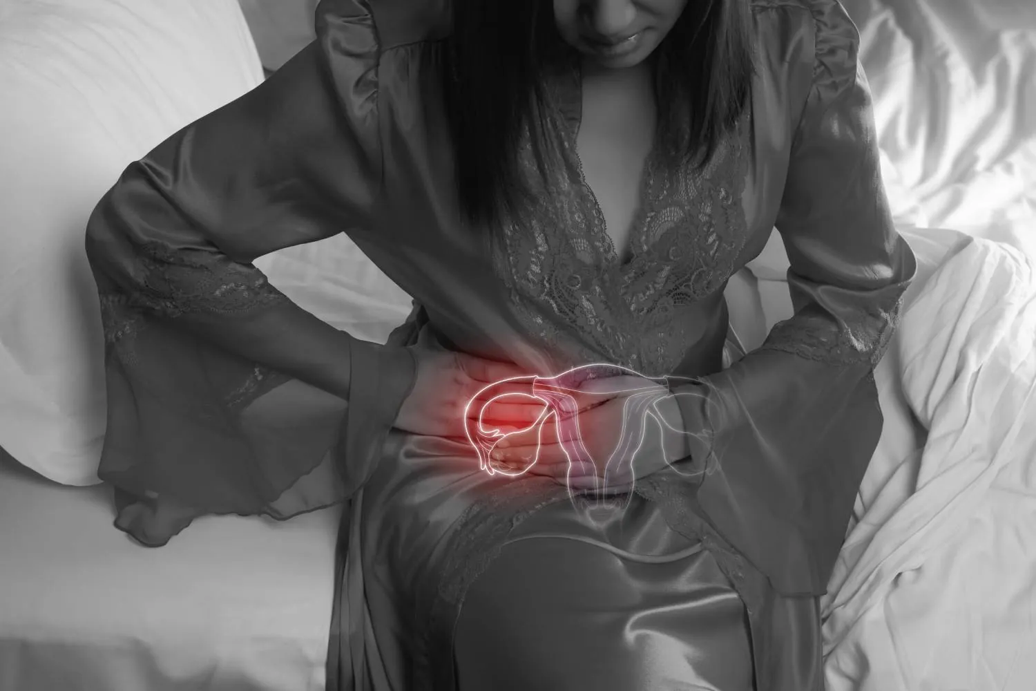 Woman in silk nightgown and lace robe with uterus pain