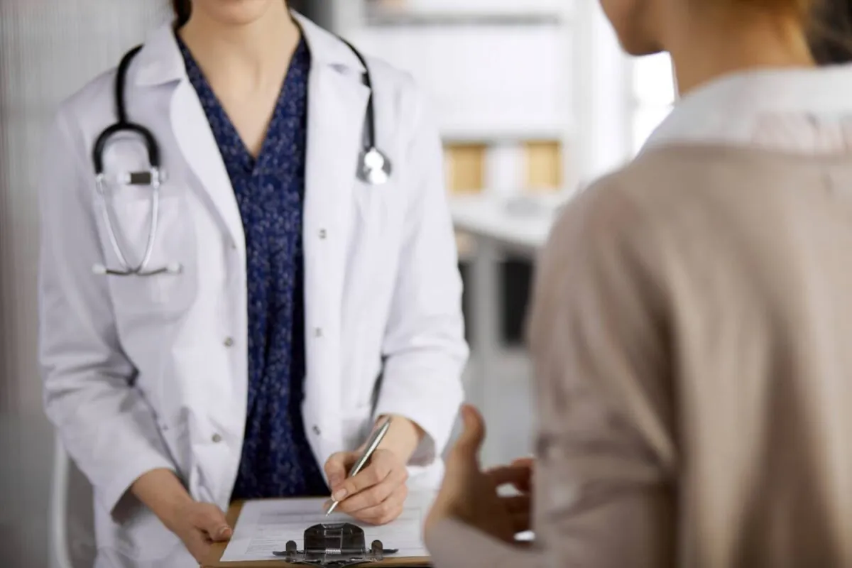 Doctor and patient discussing current health examination while sitting in clinic