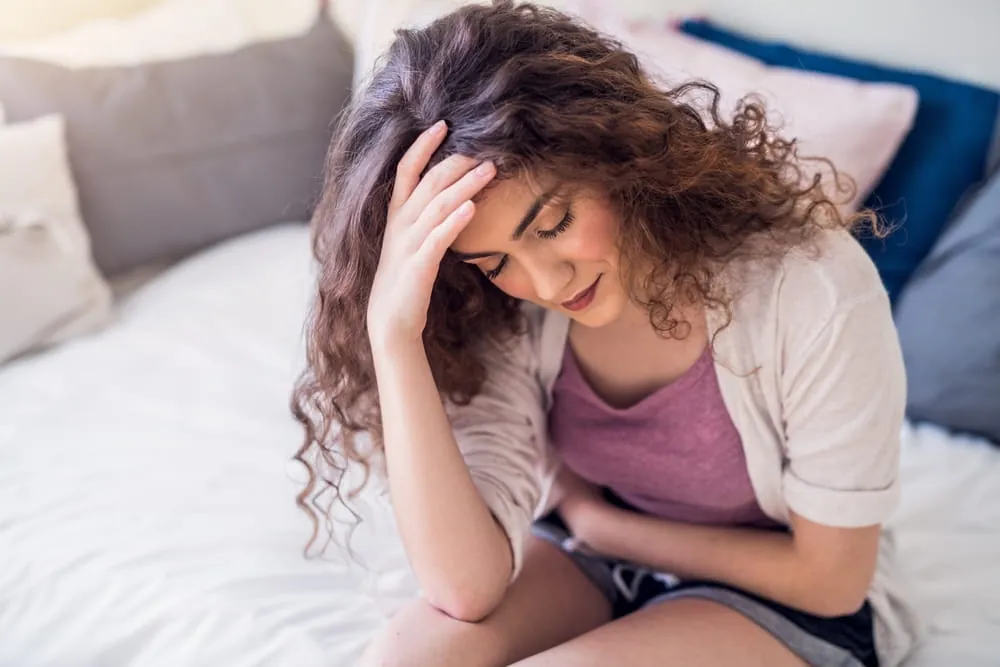 Woman suffering from menstrual pain, having cramps.